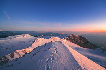 The first light of day on the snowy summit of Mt. Parnassus