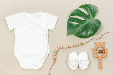Wrap bodysuit for mockup with tropical monstera leaf on a pastel beige background in eco style....
