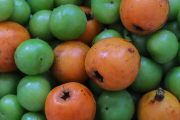 fresh loquat and plum fruit in the market