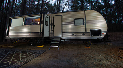 RV as night falls in a forest