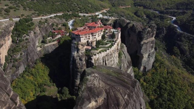 Aerial view of monastery Trinity and breathtaking pictures of valley and landmark canyon of Meteora, Polichni, Kalambaka, Greece. Mountains as columns