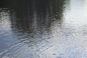 Water gray texture on the surface of a body of water with a wave