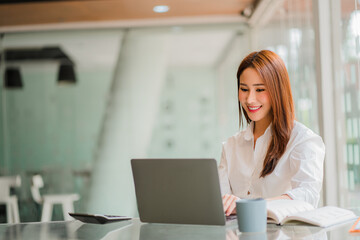 Asian businesswoman working in the office with laptop financial documents gives a clear vision of work and success instilling trust in business finance ideas.
