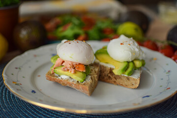 Poached Egg Benedict Toast with Avocado, Salmon and Rucola.