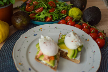 Poached Egg Benedict Toast with Avocado, Salmon and Rucola.