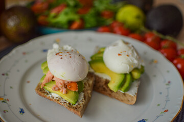 Poached Egg Benedict Toast with Avocado, Salmon and Rucola.