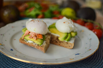 Poached Egg Benedict Toast with Avocado, Salmon and Rucola.