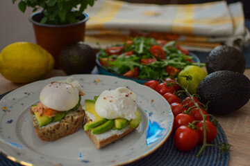 Poached Egg Benedict Toast with Avocado, Salmon and Rucola.