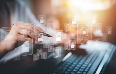 Hand using laptop and touch folder of document Management System, online documentation database and...