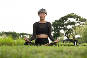 Naklejka na ściany i meble Asian Girl meditating on yoga mat.