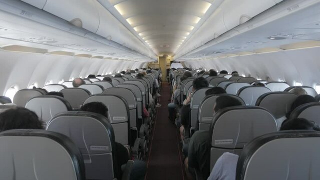 POV to the aisle pathway inside plane cabin