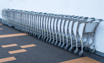 row of airport carts parking at airport