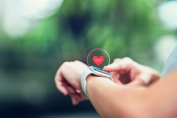 Woman using smart watches with checking pulse via health application. healthcare and people concept.