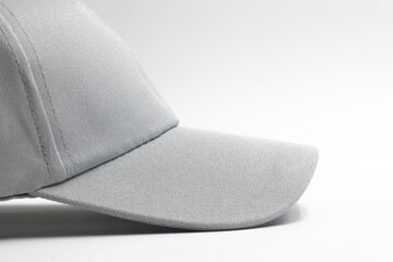 visor of light grey plain cap for men isolated on a white background, side view