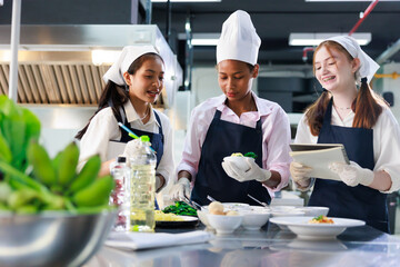 take note on book. Cooking class. culinary classroom. group of happy young woman multi-ethnic...