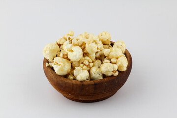 Caramel popcorn on wooden bow white background