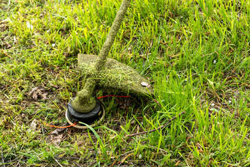 close-up of a grass trimmer during mowing. Landscaping concept