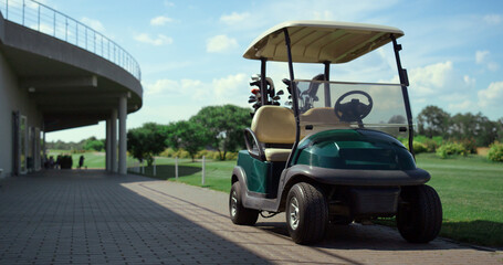 Golf cart stand field at country club. Empty car wait players on golfing game. © stockbusters