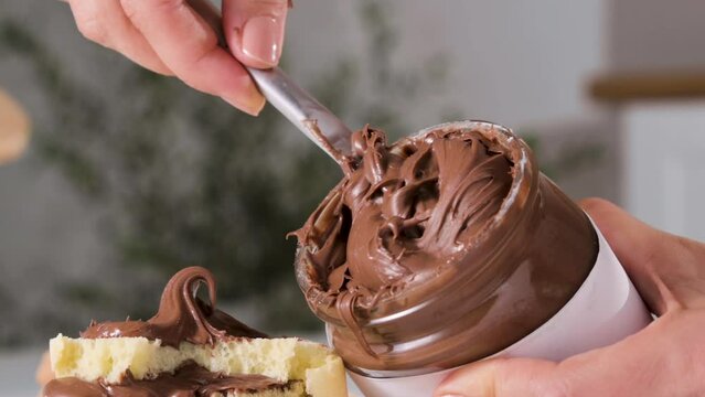 chocolate paste. Nut-chocolate paste for breakfast and favorite children's food. Closeup texture of pasta and gooey chocolate mixture. High quality 4k footage. Ideal for advertising and social posts
