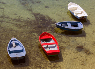 small colorful fishing boat on the coast of the mediterranean sea