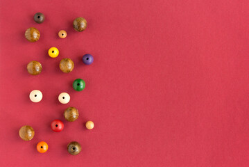 flat lay composition with decorative baubles folk beads and  space for text  on red background