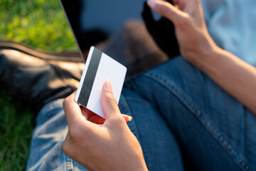 Close up of business woman hand holding credit card shopping online using modern technology, selective focus 