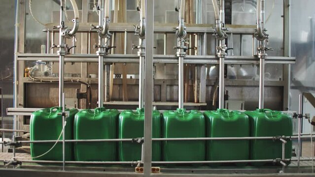 Pouring Liquid into Canisters. Micro Fertilizer Production Factory