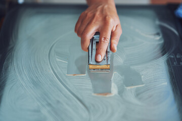 Young woman cleaning oven in the kitchen
