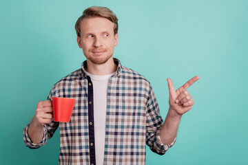 Handsome business man enjoy coffee break indicate finger away empty space sale promo look curious