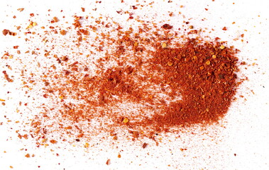 Spicy chili pepper flakes, crushed, milled dry paprika pile isolated on white, top view