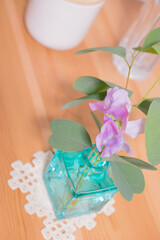 Cute little jug with eucalyptus leaves and sweet peas.