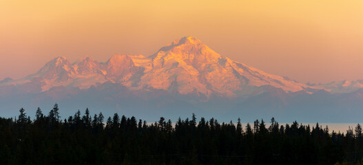 Panorama image of the glacier capped Mount Redoubt volcano from Anchor Point, Homer at sunrise