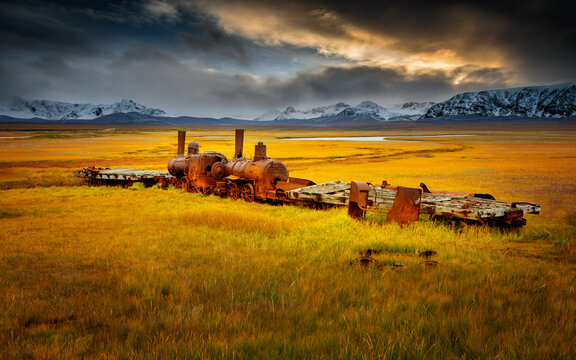 Last train to nowhere; rusty wreck of a locomotive on the tundra in autumn colors, Nome Alaska
