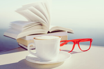 Coffee cup and books outdoors