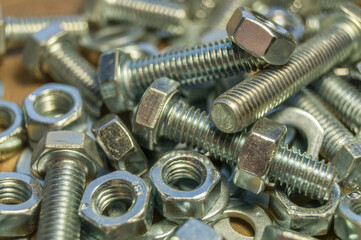 Various hardware. Metal fasteners. Bolts, nuts and washers. Soft focus, abstract, industrial background