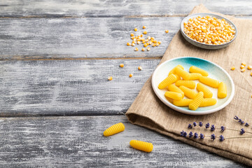 Jelly corn candies on gray wooden background. copy space, side view.