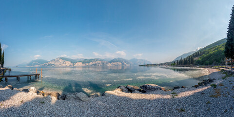 Panoramic view of the Riva del Garda lakefront, waterfront of the Garda lake in Trento, Trentino region, Italy - obrazy, fototapety, plakaty