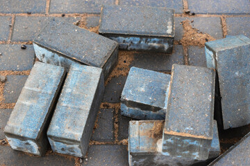 Gray paving slabs at a construction site. Material for paving roads and sidewalks. Close-up. Concrete tiles.
