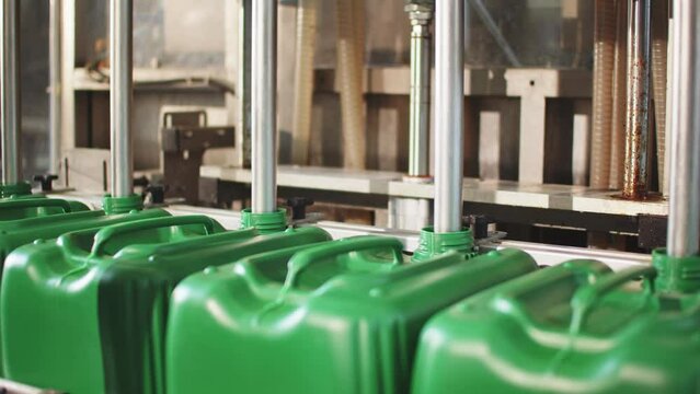 Pouring Liquid into Canisters. Micro Fertilizer Production Factory
