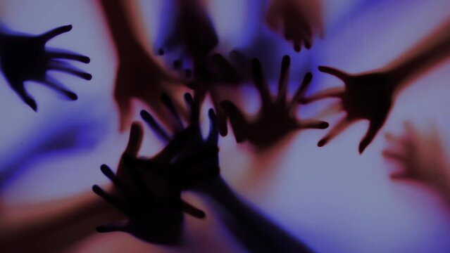 Shadow of a zombie's hand in red and blue scene., Slow motion
