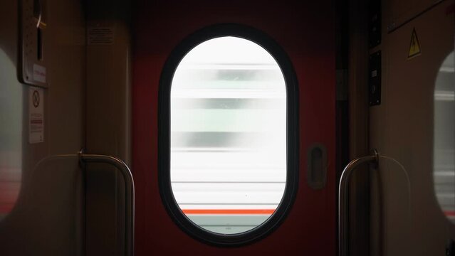 Bullet train rides on the railway track. Journey and trip on train. Interior view at train's empty window.