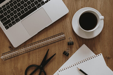 Aesthetic home office desk workspace. Laptop computer, notebook, coffee cup on wooden table. Influencer lifestyle blog background