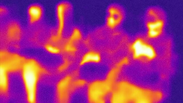 People in transport. Broadcasting from thermal imager device. Human heat map. Blurred unrecognizable people.