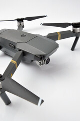 A gray camouflaged drone with a camera used for military espionage isolated.