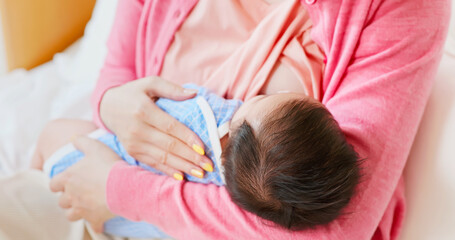 Obraz na płótnie Canvas asian mother breastfeeding baby