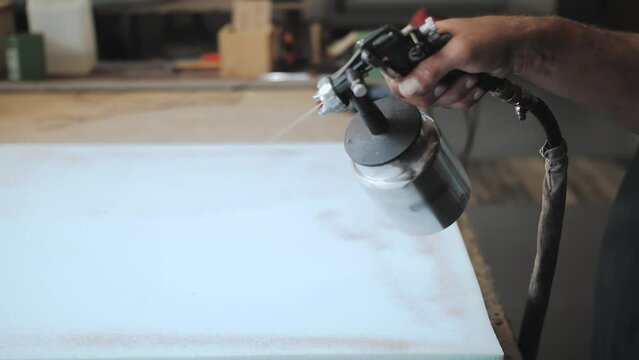 The factory for the manufacture of upholstered furniture. Gluing of foam rubber. The process of assembling and gluing upholstered furniture. Close-up. Unrecognizable 