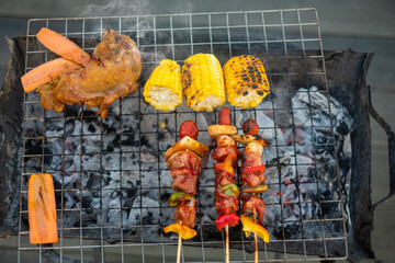 delicious grilled meat with smoke, BBQ with vegetables in outdoor. Barbecue, Party, lifestyle and...