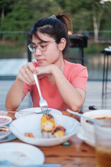 Happy woman eating dinner with delicious grilled meat and BBQ in outdoor. Barbecue, Party, lifestyle and picnic concept