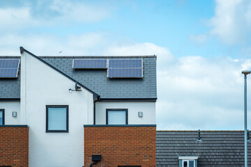 Solar panels mounted on the roof of a modern new-build house in England UK