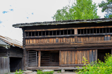 Wooden, vintage log shed in the countryside.